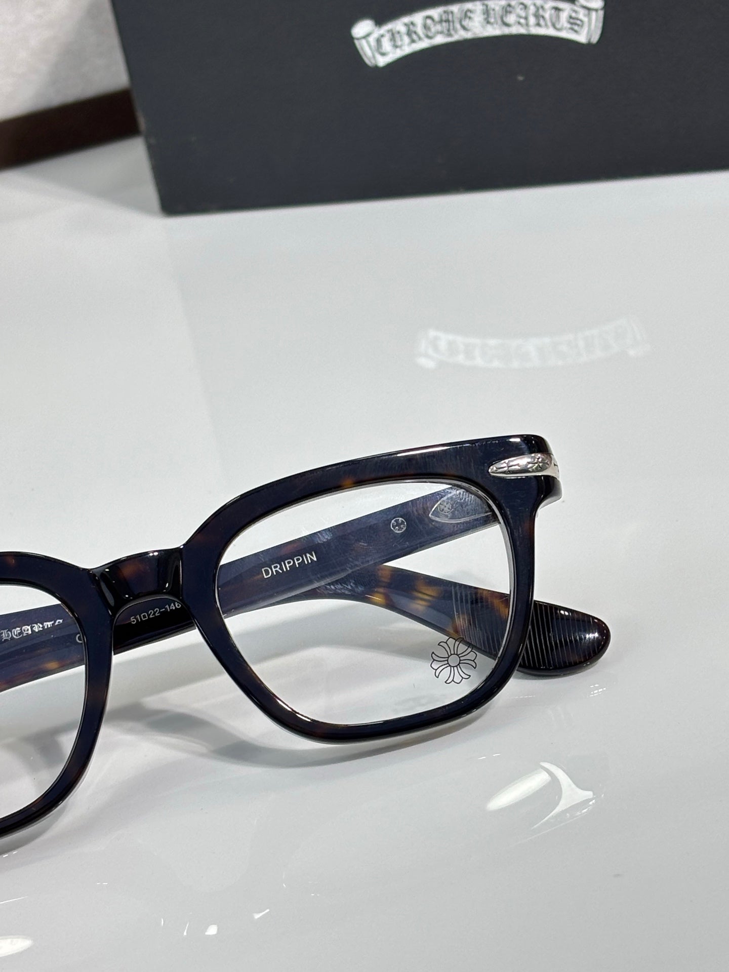Navy full-rim eyeglasses with logo detail on the temple and round-rectangular lenses