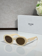 Celine sunglasses with rounded cream frames and dark tinted lenses