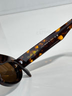 Celine sunglasses side temple close-up on amber tortoiseshell with printed text