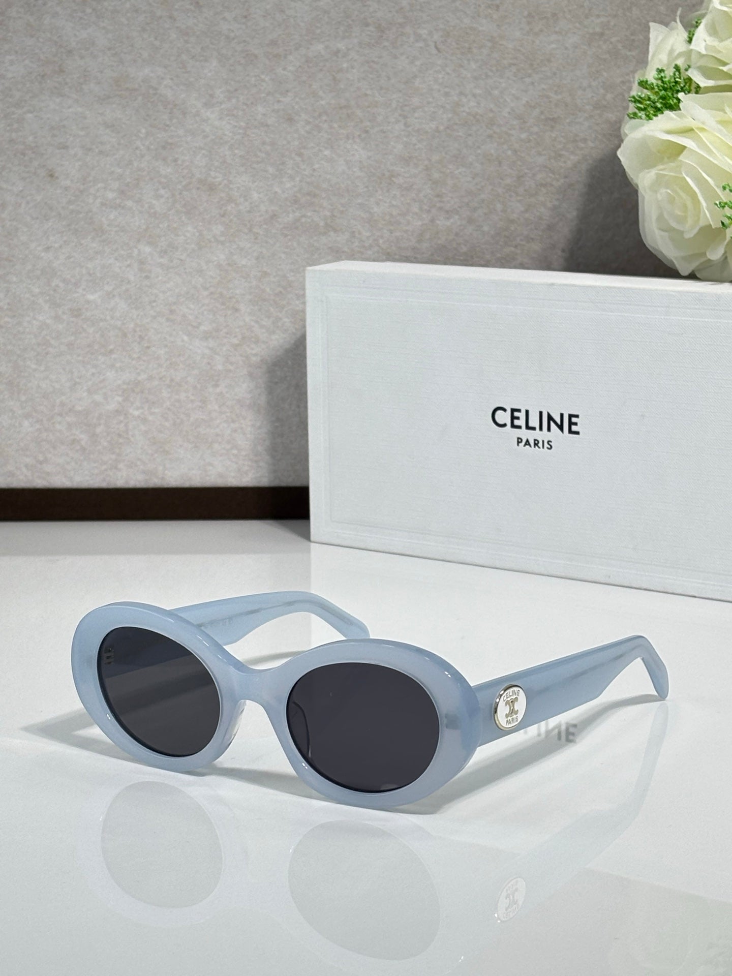 Celine sunglasses with rounded light blue frames and dark tinted lenses