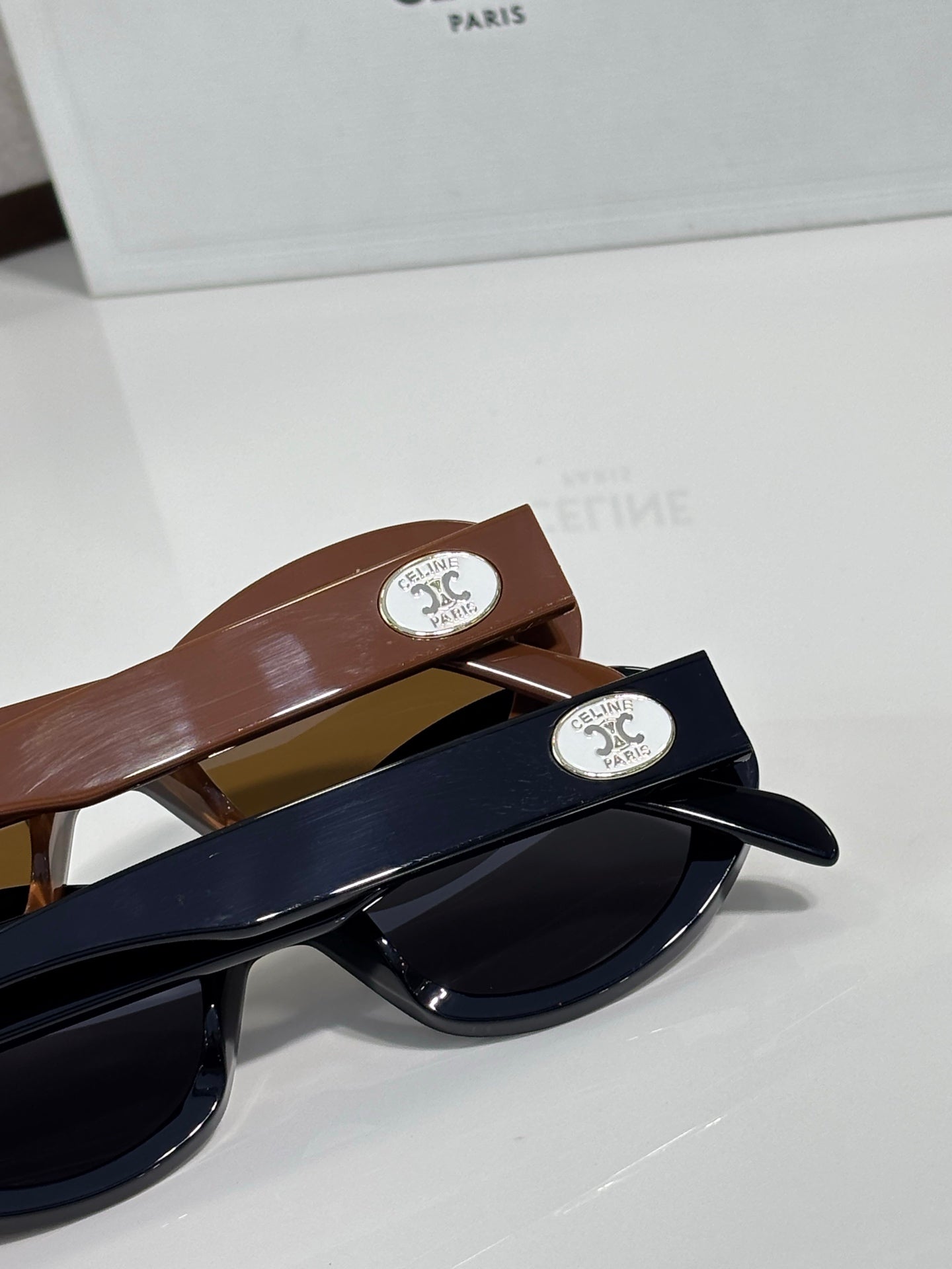 Celine sunglasses temple detail with logo plaques on brown and navy frames