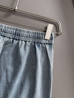 Louis Vuitton light blue denim pants close-up, elastic waistband and drawstring