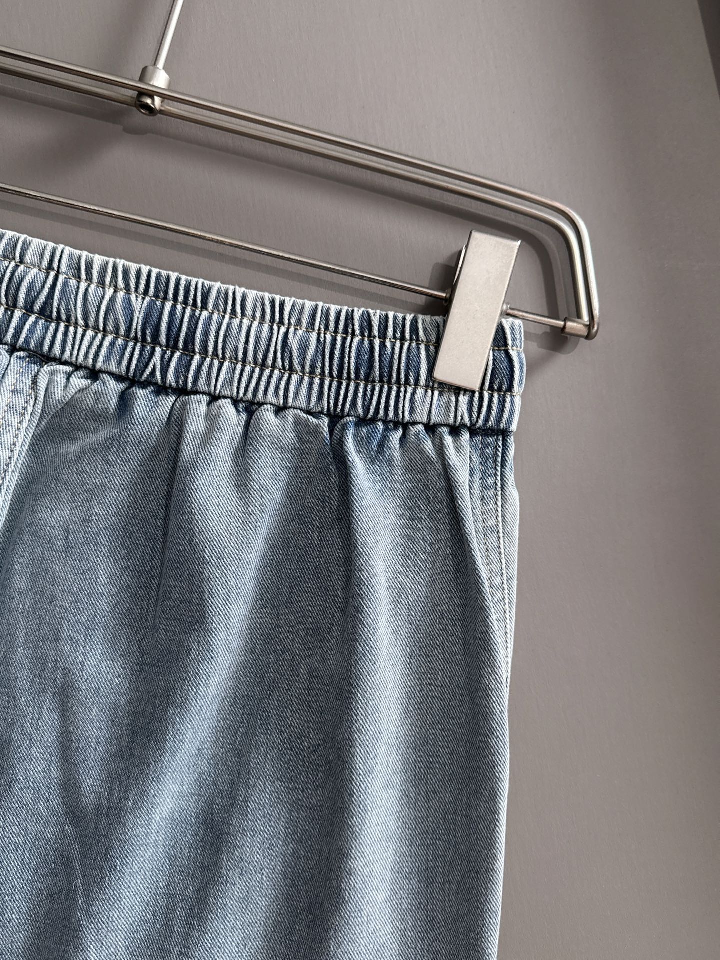 Louis Vuitton light blue denim pants close-up, elastic waistband and drawstring