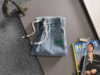 Louis Vuitton light blue denim jogger pants with elastic waistband and drawstring, cargo pockets