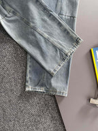 Light blue denim pants with cuffed hem and stitched leg seams