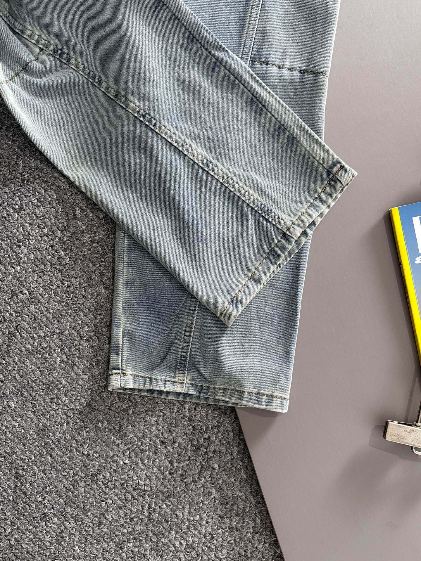 Light blue denim pants with cuffed hem and stitched leg seams