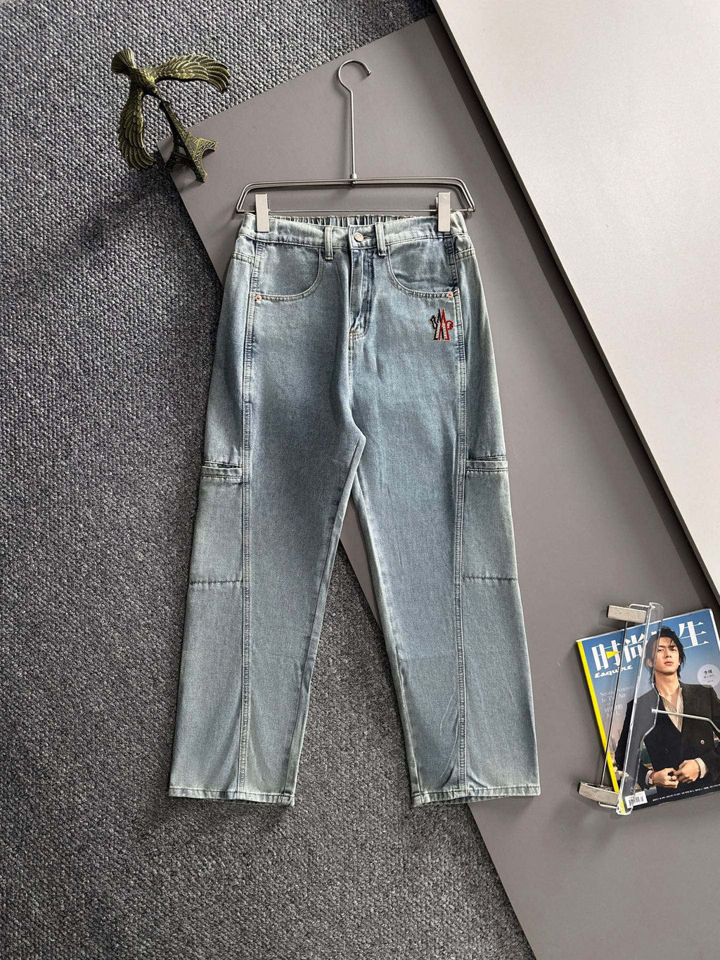 Light blue denim pants with belt loops, front button, and flap cargo-style pockets