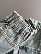 Light blue denim pants close-up of waistband and belt loops