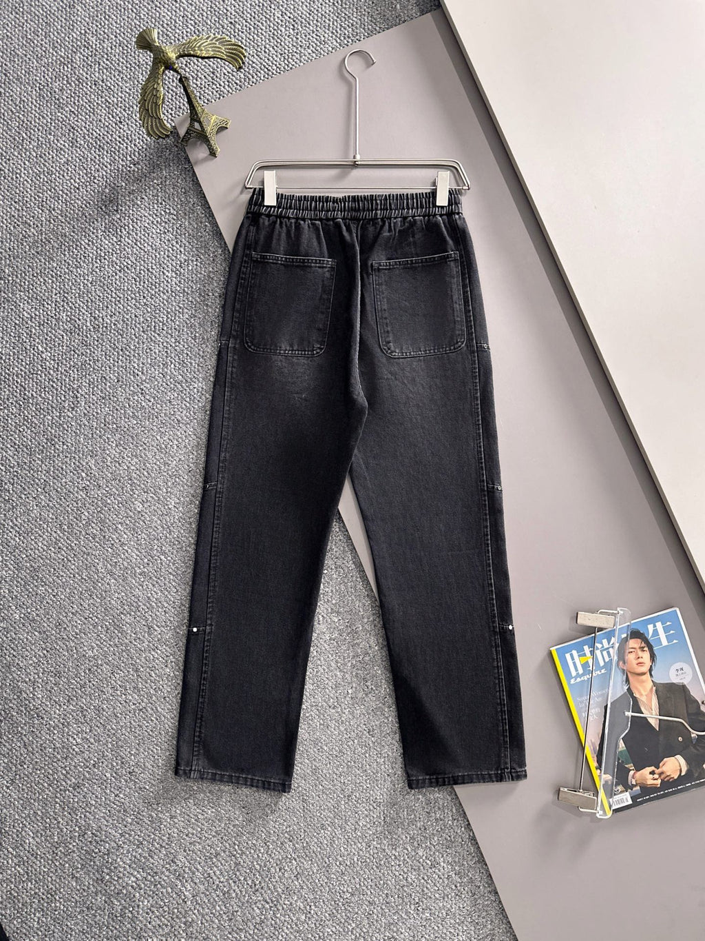 Dior dark denim pants on hanger, elastic waistband and straight tapered legs