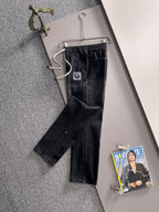 Dior dark denim pants with cuffed hems, drawstring waist and straight leg