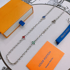Charm necklace with silver chain and multicolor enamel flower and heart pendants