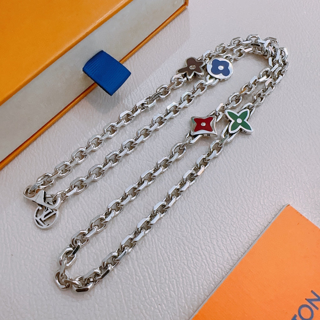 Silver charm necklace with blue and green flower charms and red heart charm