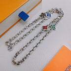 Silver charm necklace with blue and green flower charms and red heart charm