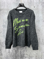 Dark gray fuzzy knit sweater with neon green graphic lettering on chest