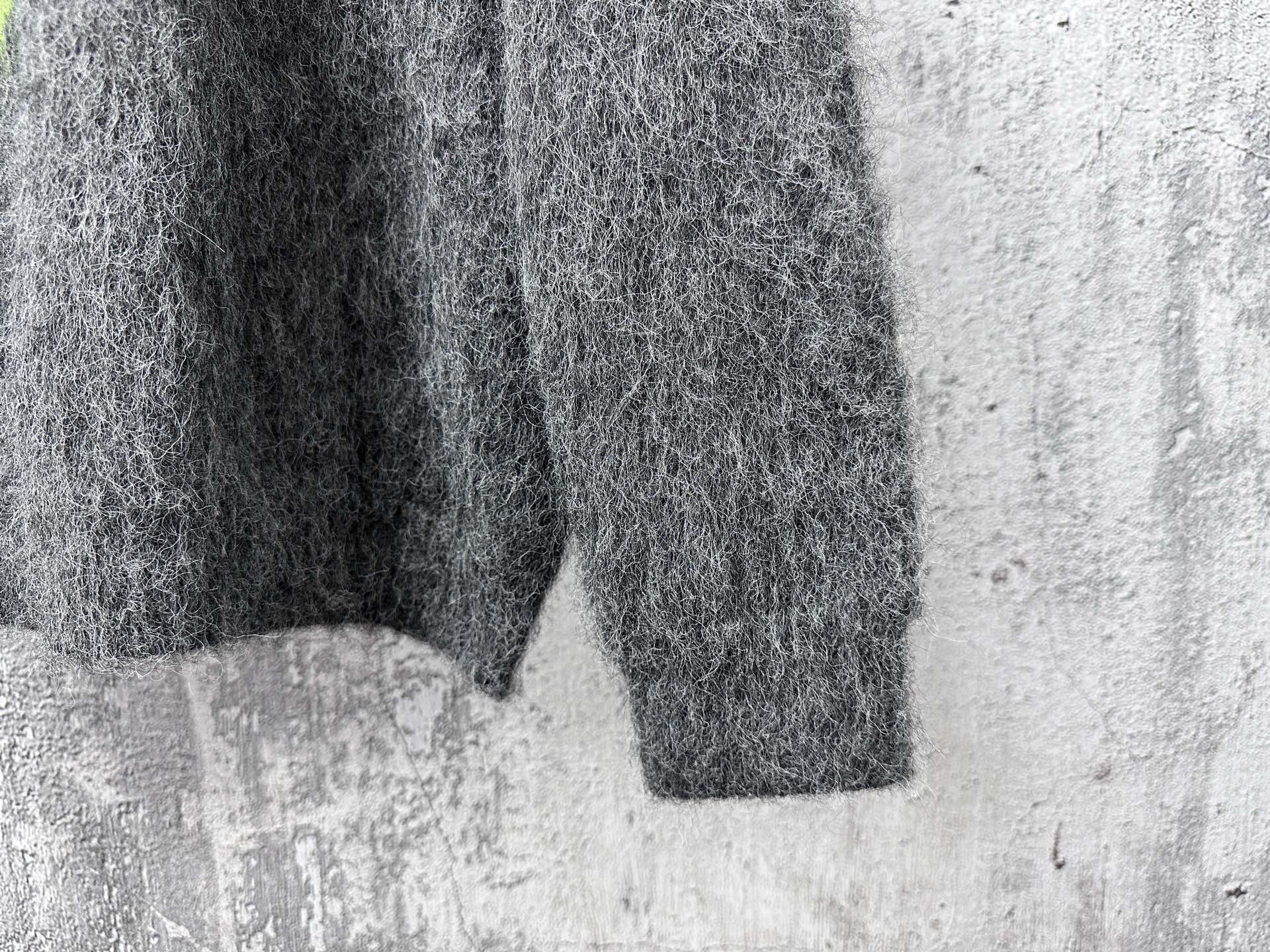 Dark gray fuzzy knit sweater sleeve and hem with straight cuffs