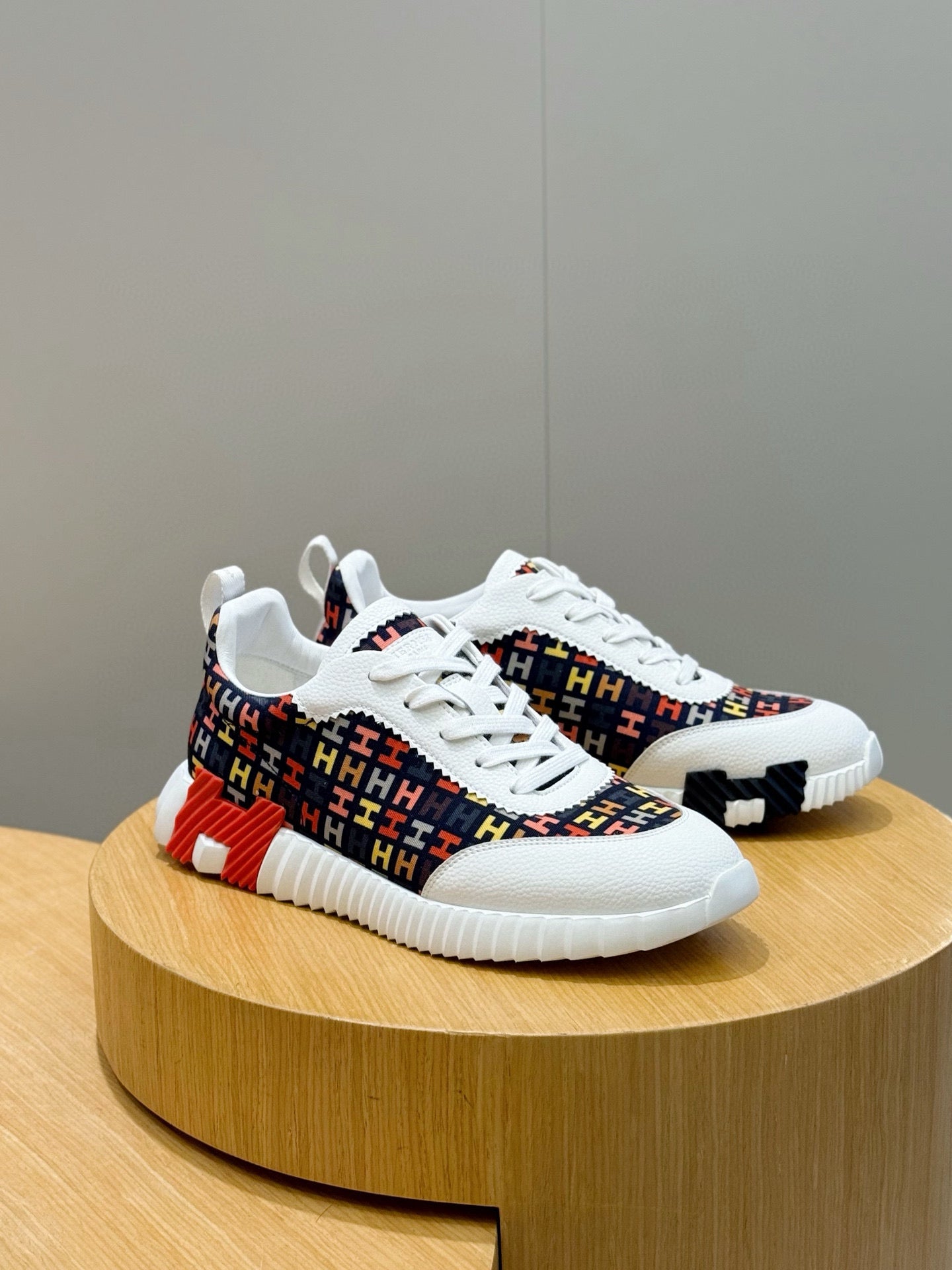 Hermes unisex sneakers, front three-quarter view, white laces and red/blue pattern