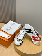 Hermes unisex sneakers, outsole view with red/blue tread and white rubber sole