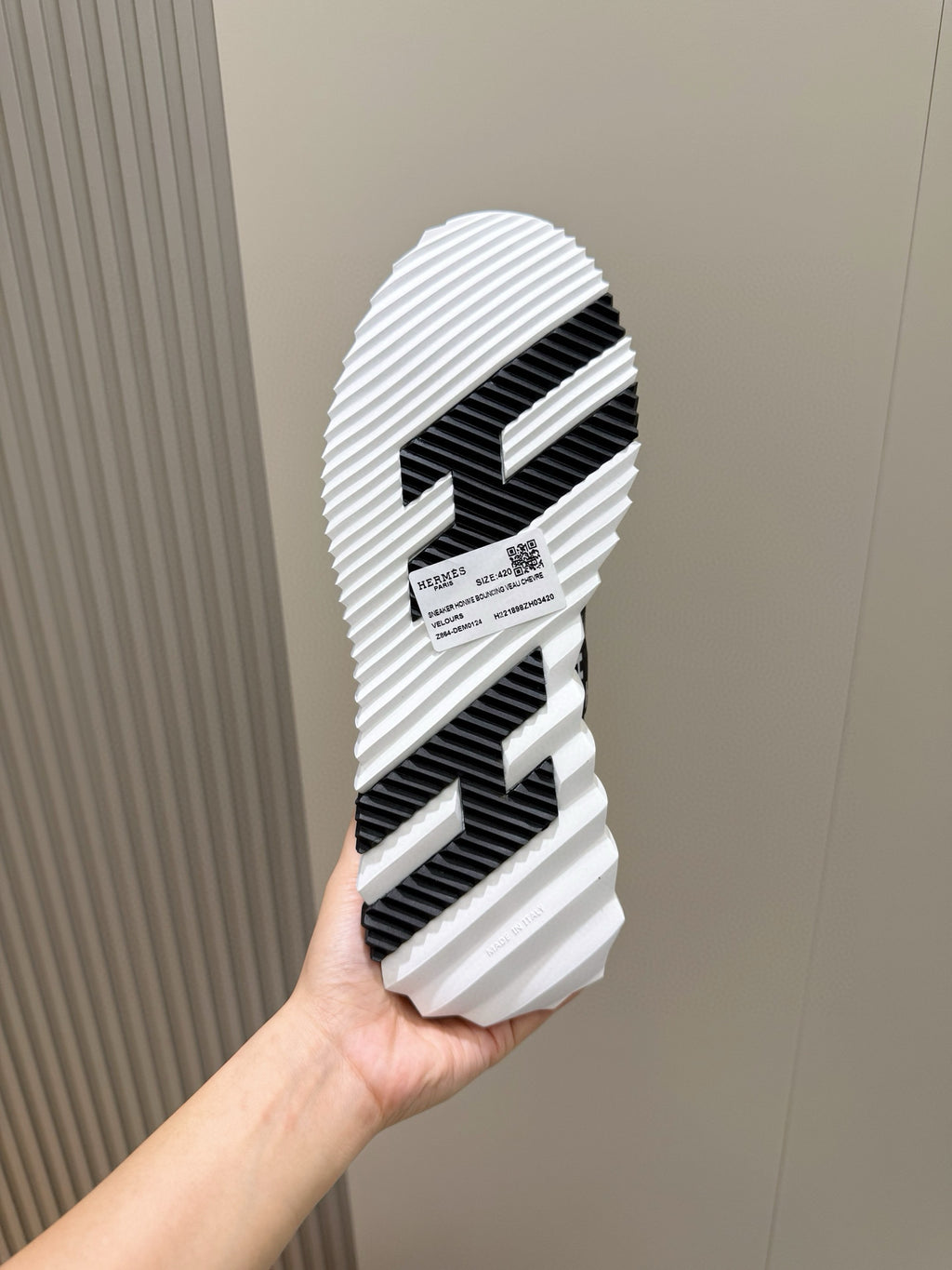 Black-and-white sneaker outsole with molded tread pattern and striped rubber grooves
