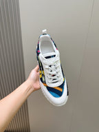 White sneakers with blue, red, and yellow patterned side stripe and white laces