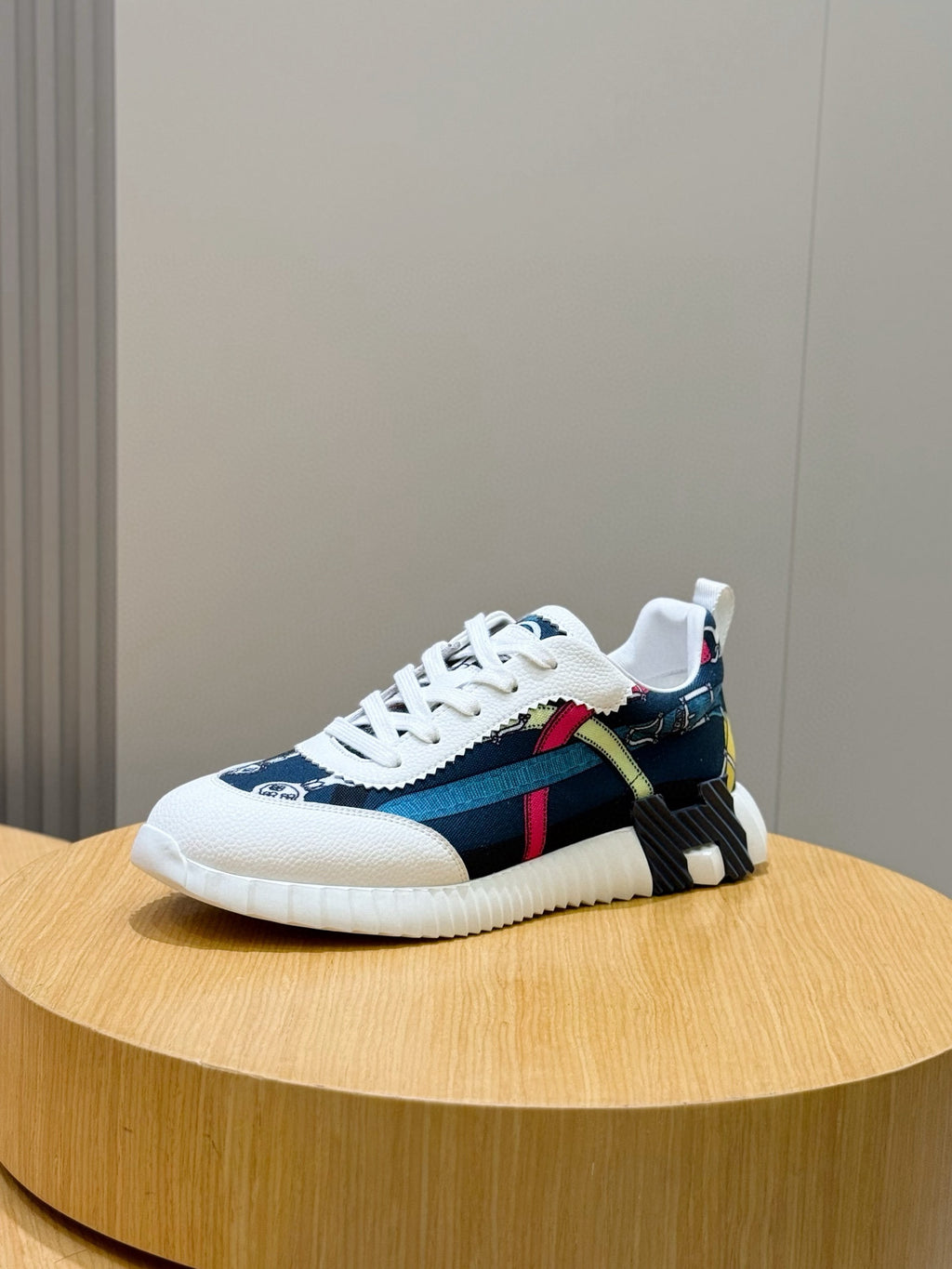 Blue and white sneakers with striped panels, multicolor accents, and white laces