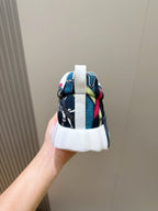 Sneaker heel with blue textile print, colorful accents, and white midsole