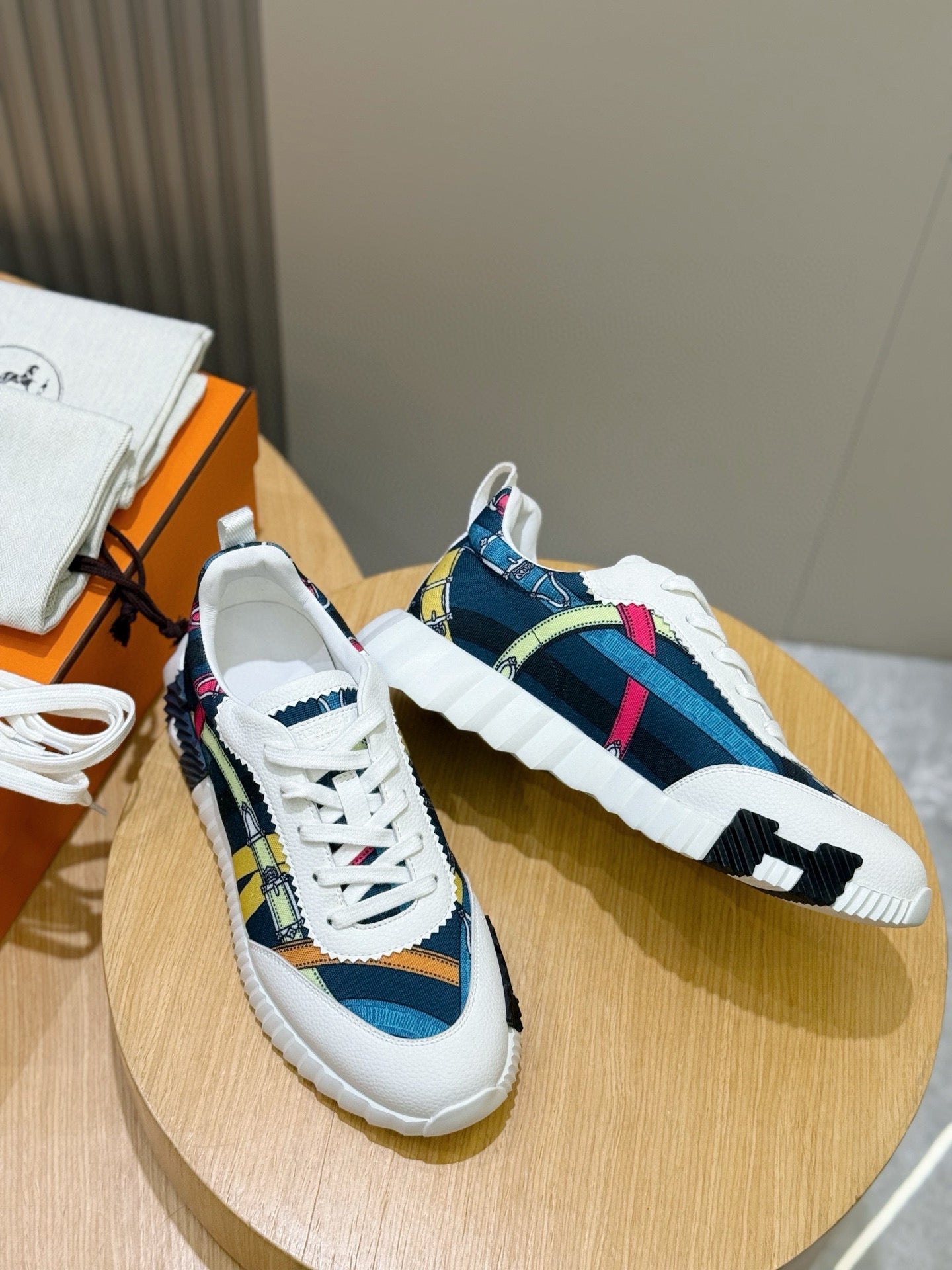 Pair of white-and-blue sneakers with multicolor stripe detailing and thick rubber soles