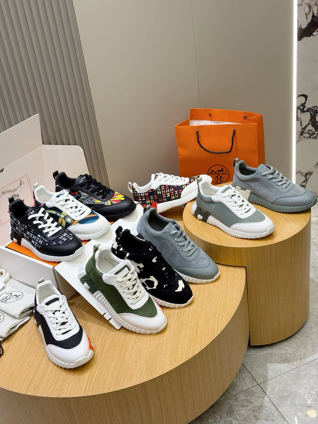 Set of sneakers on display: black, green, blue, and white styles with laces