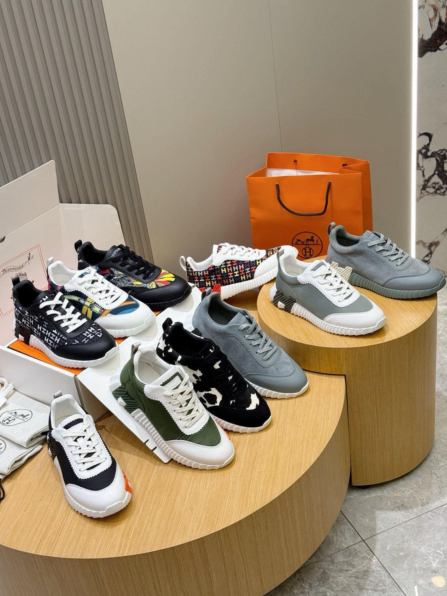 Set of sneakers on display: black, green, blue, and white styles with laces