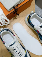 White sneakers with multicolor side stripes and white rubber soles