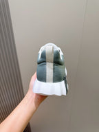 Hermes unisex lace-up sneaker heel view, white sole with vertical gray heel stripe