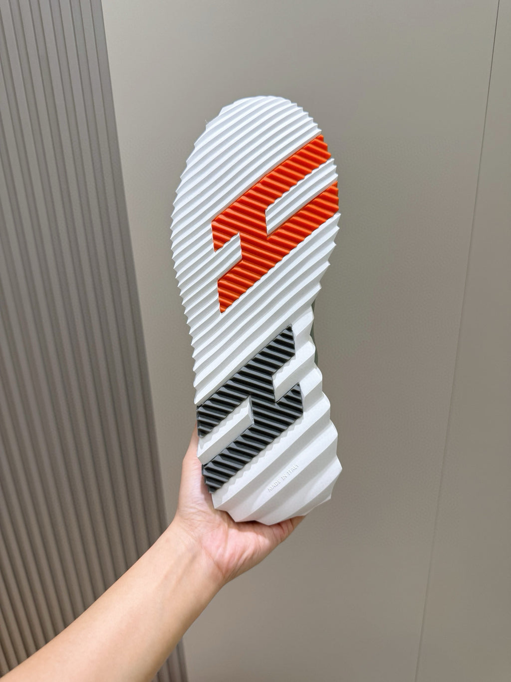 Hermes unisex sneaker outsole, white tread with orange graphic logo