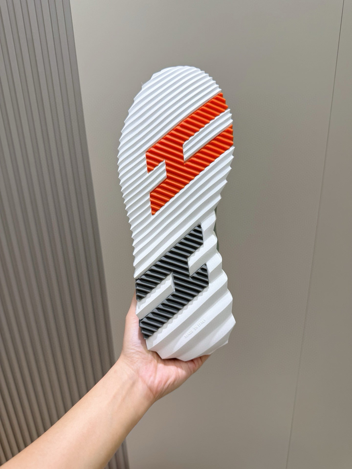 Hermes unisex sneaker outsole, white tread with orange graphic logo