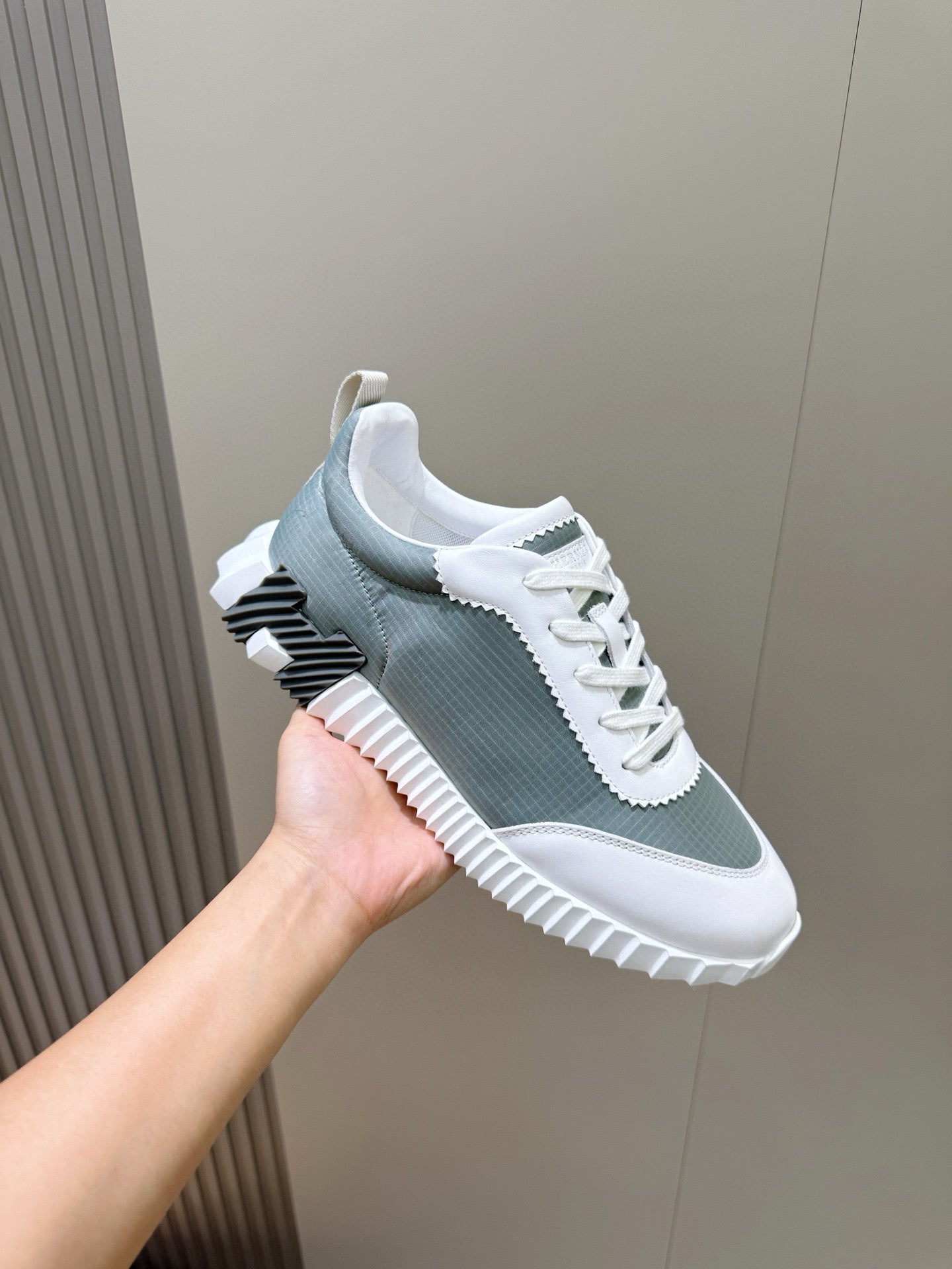 Hermes unisex lace-up sneaker, gray-green knit upper with white laces and striped sole