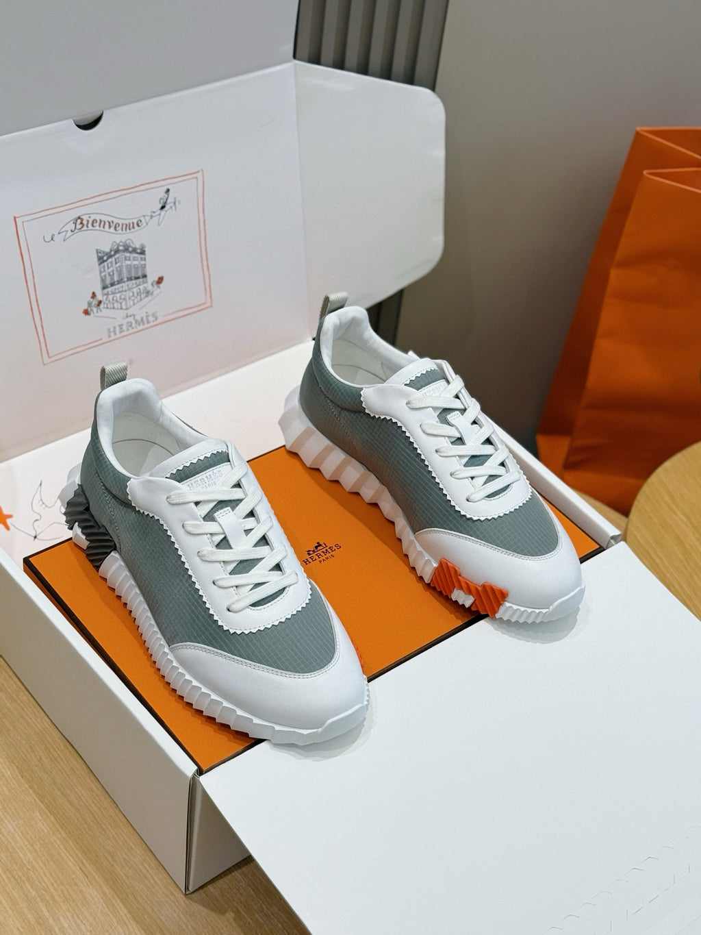 Hermes unisex lace-up sneakers, white/gray mesh uppers, orange sole accents