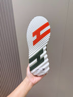Hermes unisex sneaker outsole, striped tread with orange and green accents