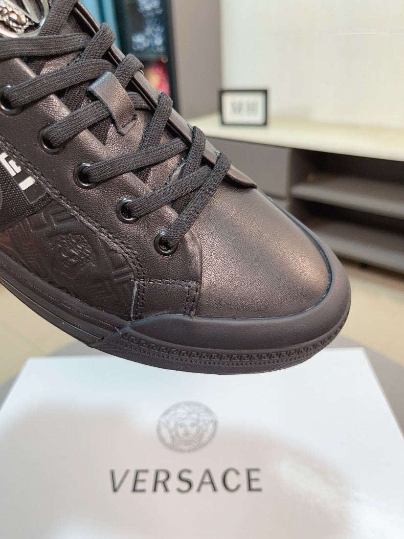 Leather low-top sneakers in dark gray, lace-up with embossed logo detailing