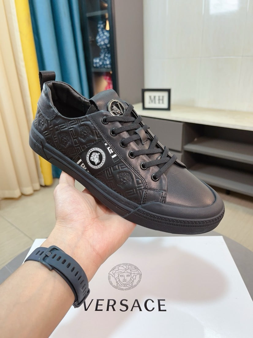 Low-top sneakers in dark gray leather, lace-up with embossed logo pattern
