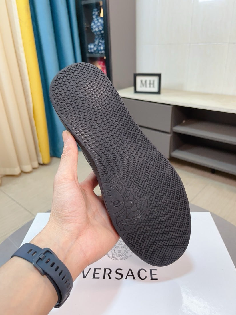 Sneaker outsole, dark gray textured tread with embossed logo pattern
