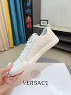 Versace low-top sneakers in white, side view with textured upper and lace-up