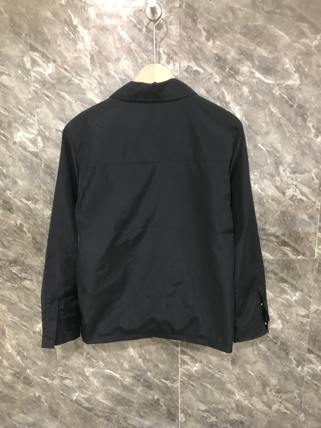 Moncler black long jacket back view with button collar and seam lines