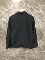 Moncler black long jacket back view with button collar and seam lines