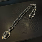 Silver-tone charm necklace with teardrop heart pendant and decorative link chain