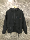 Black hooded long jacket with zip front, drawstring hem, and utility pockets