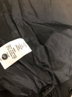 Black jacket interior view with fabric label marked size S