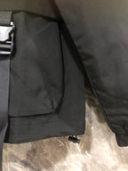 Black hooded jacket with front pocket flap and adjustable shoulder strap
