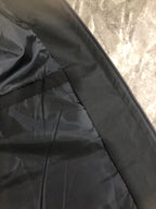 Black jacket zippered interior panel with stitched seam detail