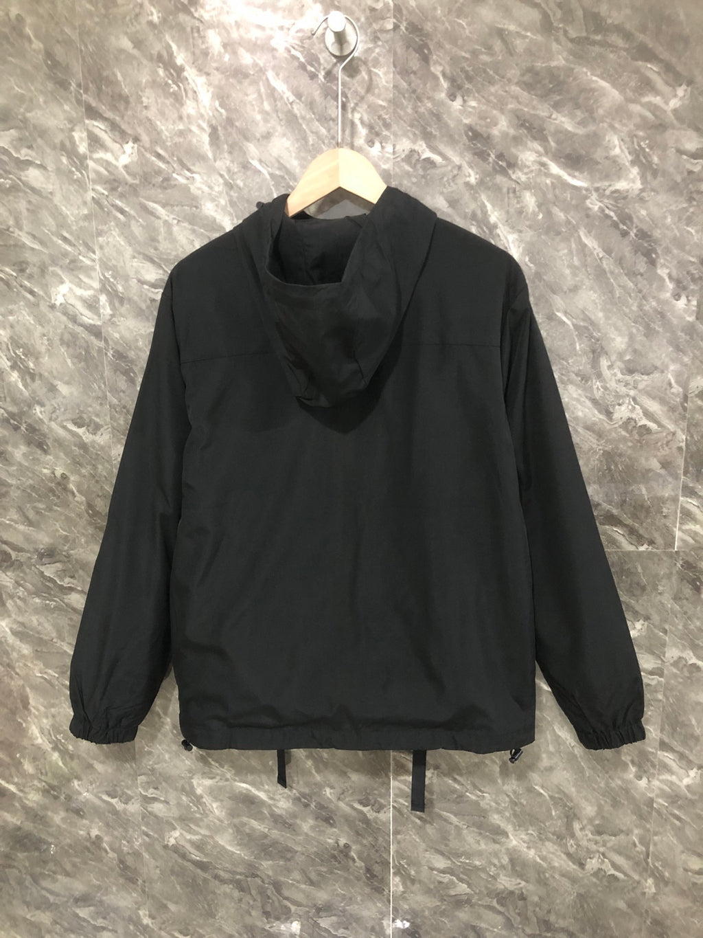 Black hooded long jacket with zip front and relaxed gathered hem