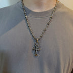 Chrome accessories cross pendant necklace worn, silver-tone chain with cross charm