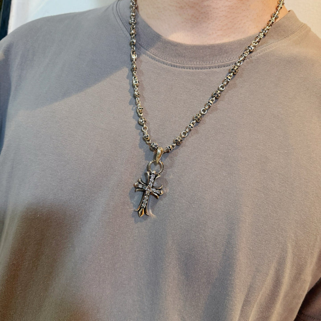 Chrome accessories cross pendant necklace worn, silver-tone chain with large cross pendant