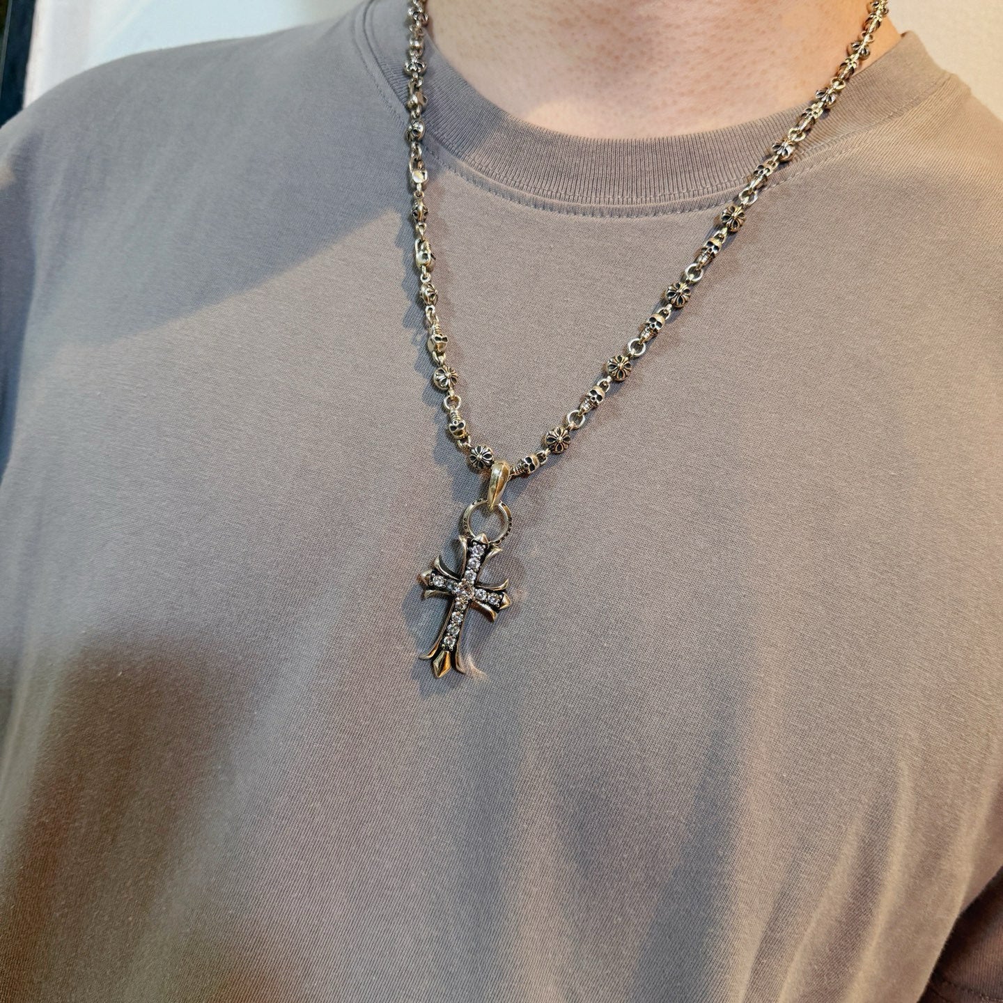 Chrome accessories cross pendant necklace worn, silver-tone chain with large cross pendant